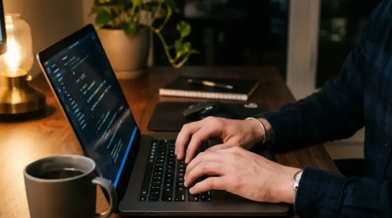 A close-up of a laptop screen displaying a detailed spreadsheet with technical codes, item numbers, and structured data in rows and columns.