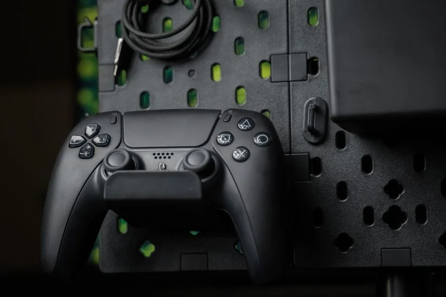 Gaming controller connected to computer using black USB data cable on desk